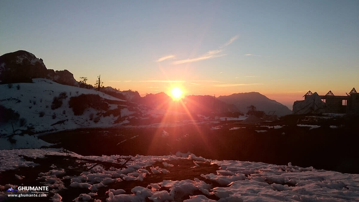 Dusk at Kuri: Photo delivers the mesmerizing view of setting sun from Kuri village with snowy hills.