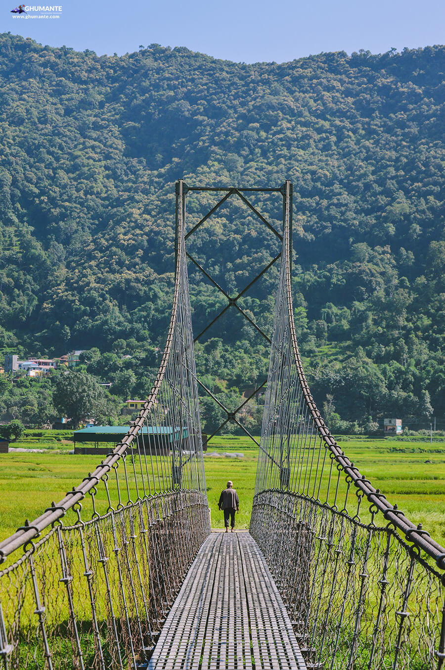 An elderly man crosses the suspension bridge that connect Amale and Mirdi Bajar